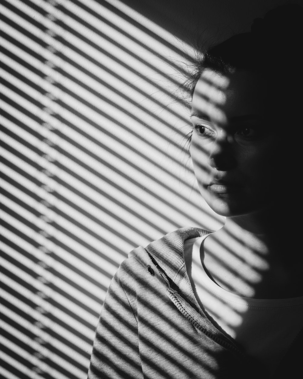 grayscale photo of woman in white and black stripe shirt