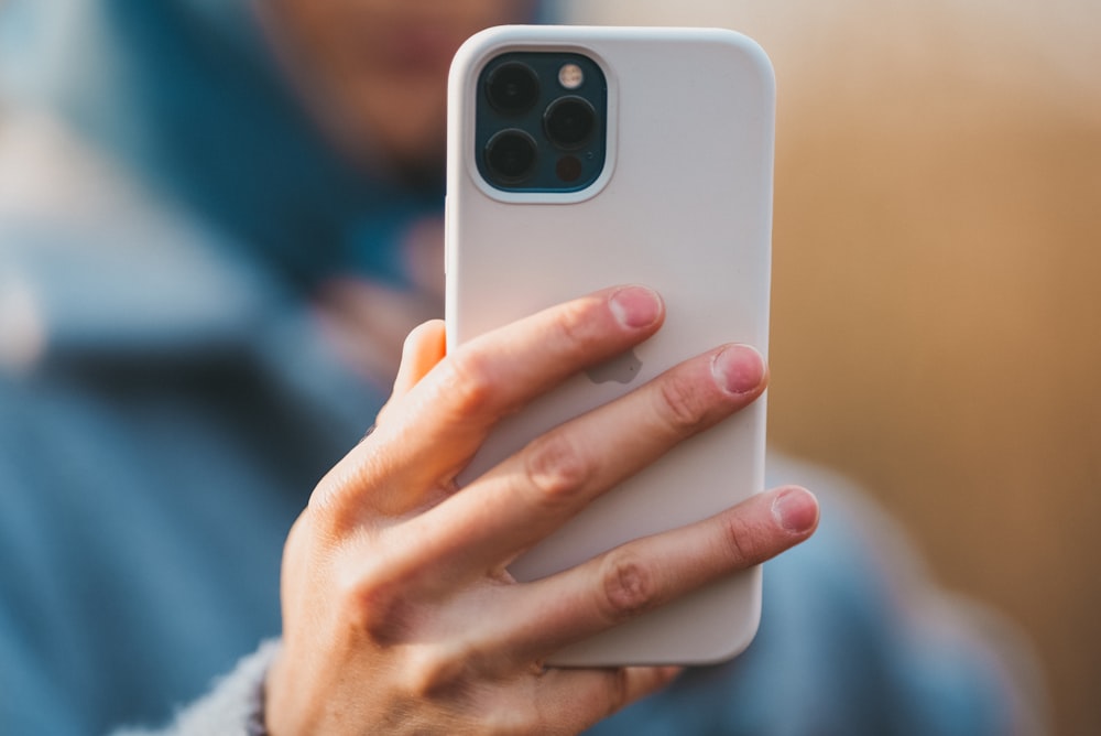 person holding white samsung android smartphone