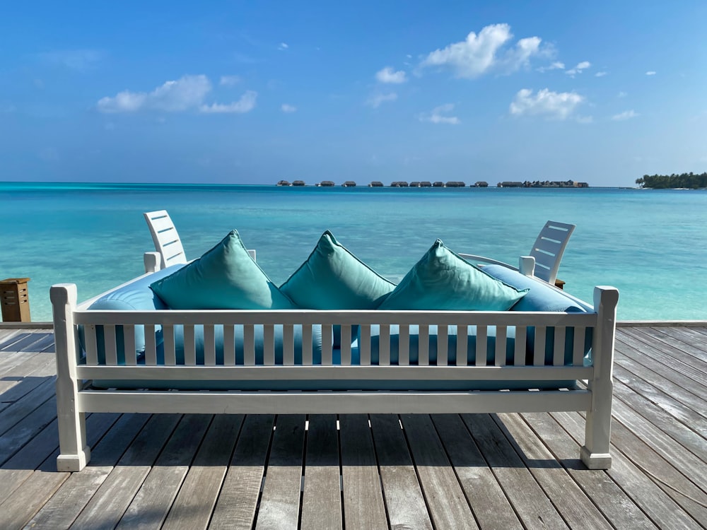 white wooden bench on sea dock during daytime