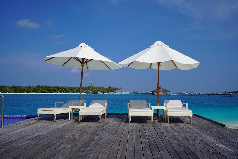 white and brown patio umbrella on brown wooden dock during daytime