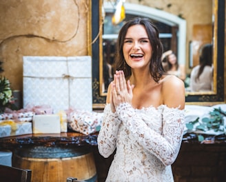 woman in white floral off shoulder dress smiling