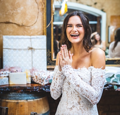 woman in white floral off shoulder dress smiling