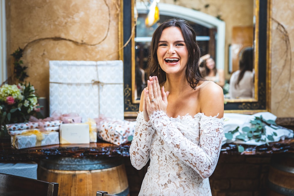 woman in white floral off shoulder dress smiling