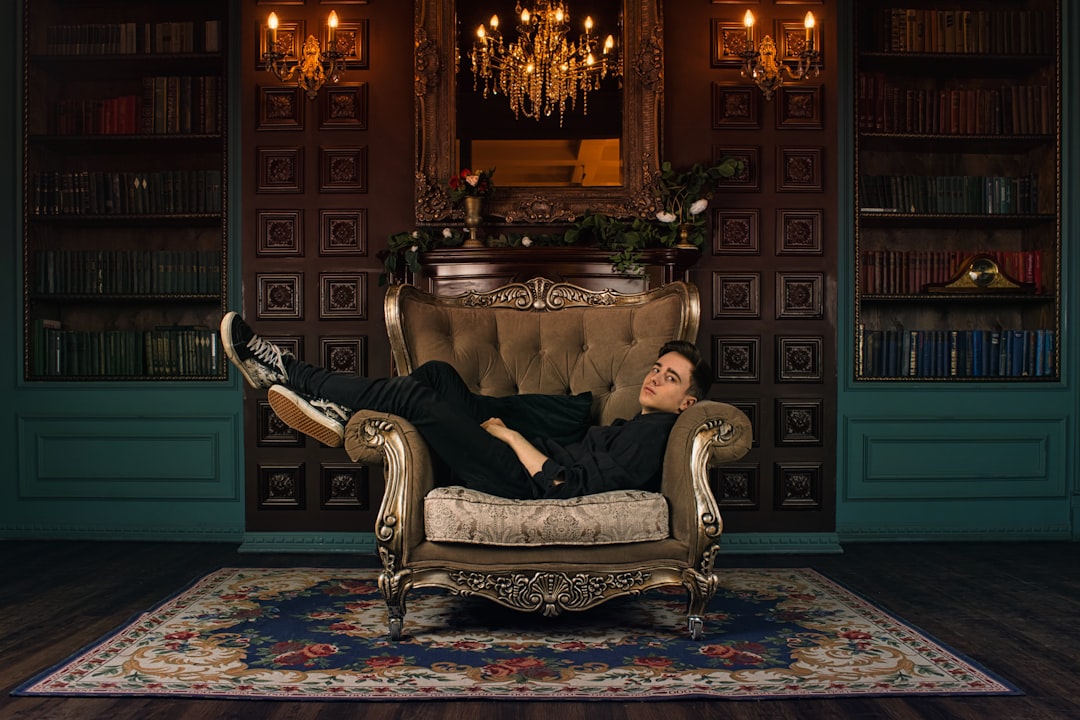 man in black jacket sitting on gray sofa chair, A young man is resting in an university library<p></figure>Photographer: https://www.instagram.com/aginsbrook/ Model: https://www.instagram.com/schweppes_psina/