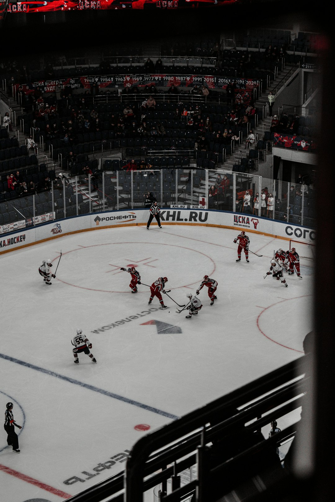 people playing ice hockey inside stadium
