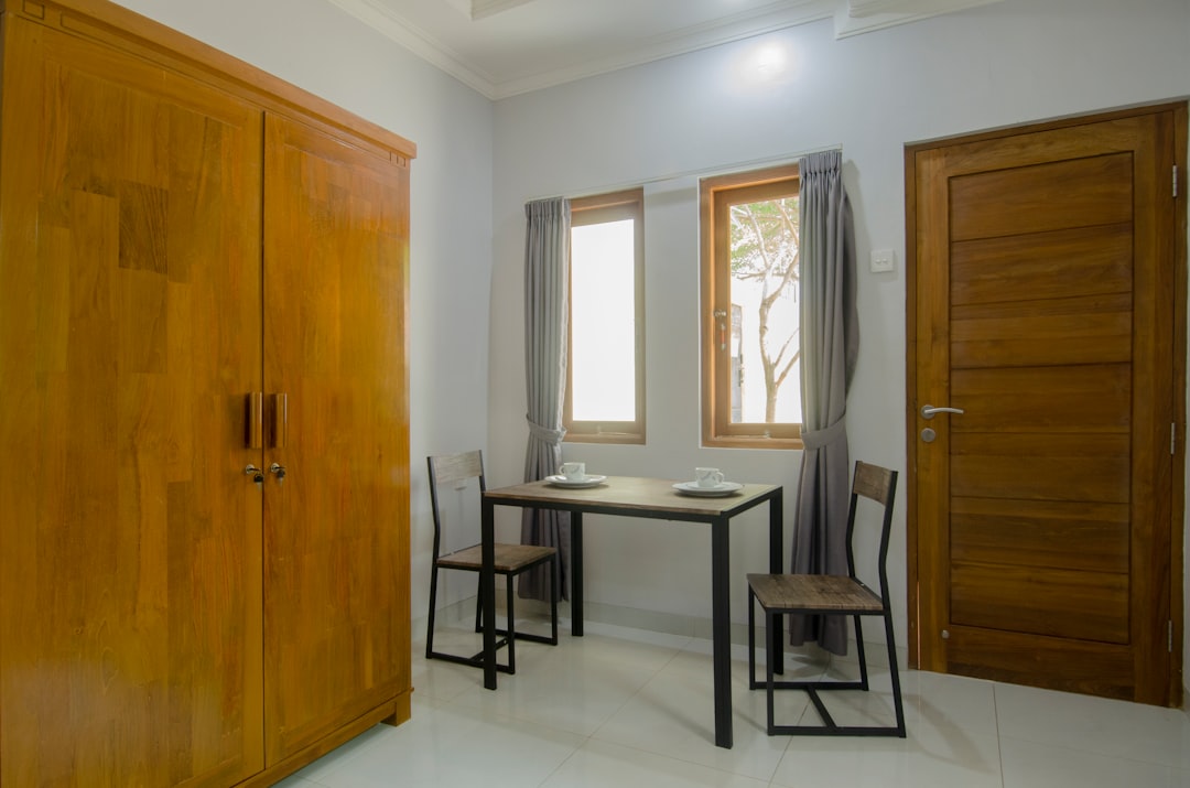 brown wooden cabinet near white table