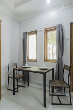 Contemporary dining table set with minimalist chairs in a bright room