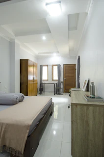 Peaceful bedroom showing neat, simple furnishings designed for comfort and privacy