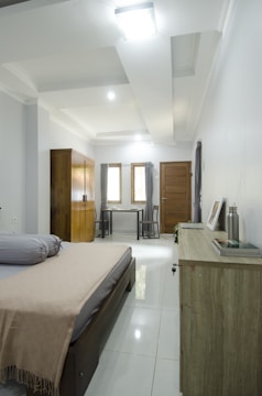 Bedroom with soft pastel walls and neat, modern decor.