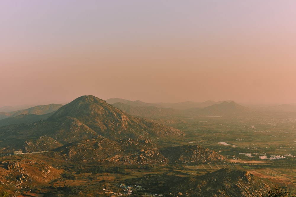 green and brown mountains under white sky during daytime