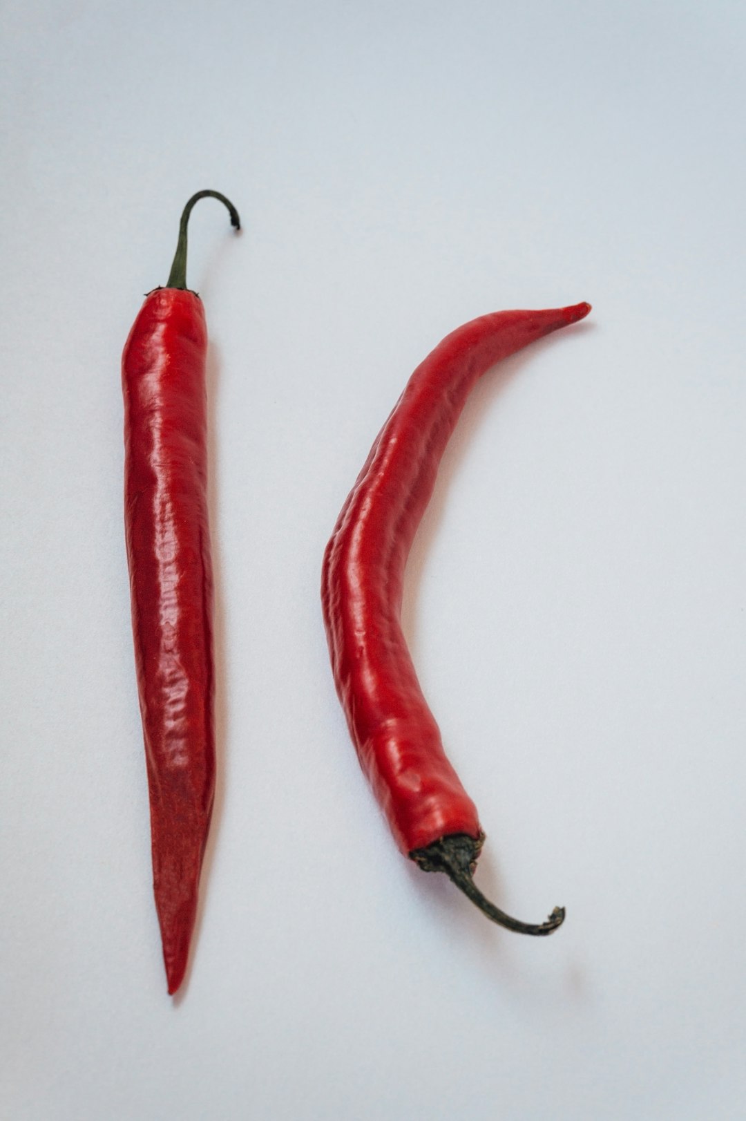 3 red chili on white surface