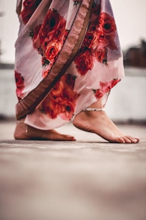 person in red and white floral skirt