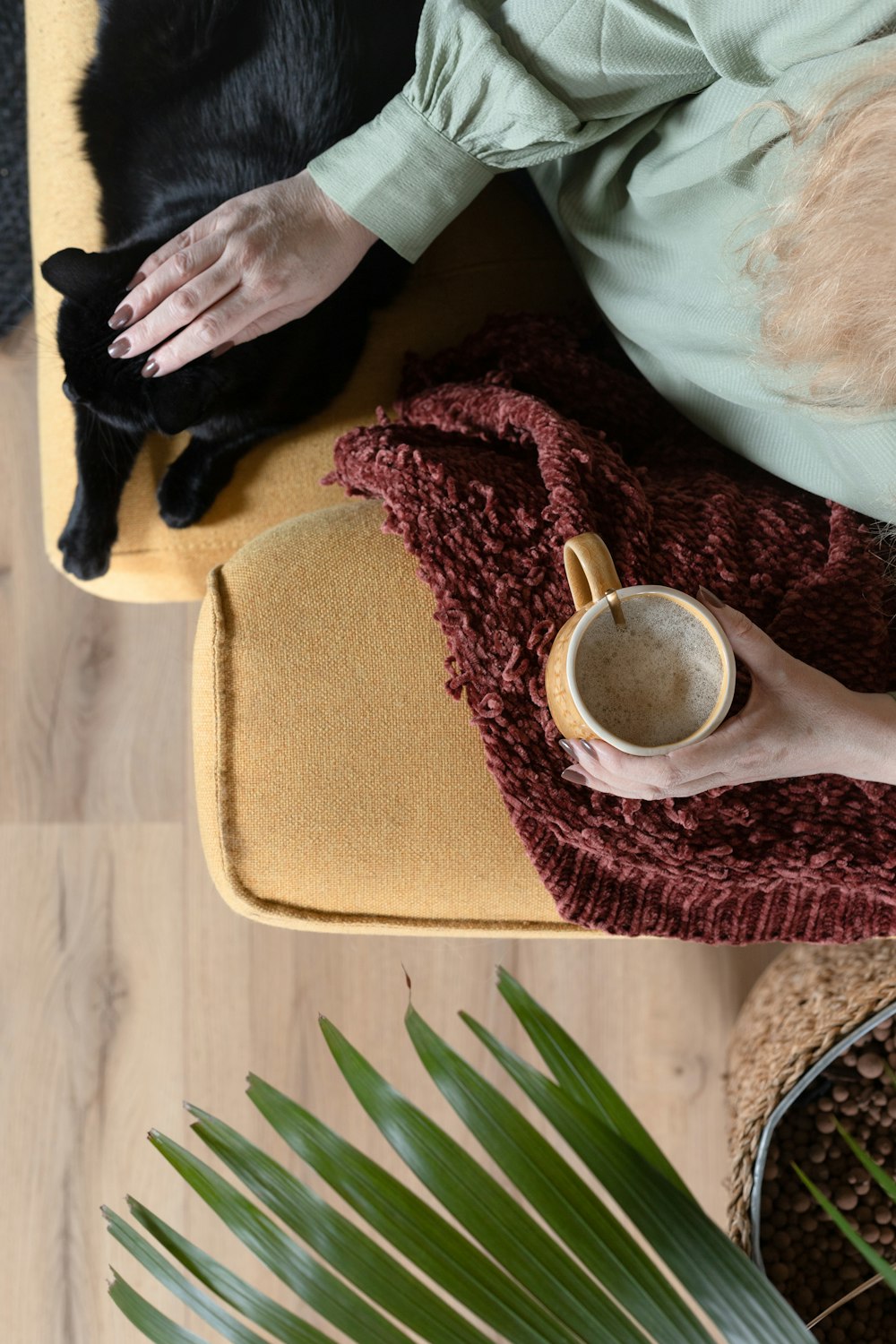 person holding white ceramic mug with brown liquid