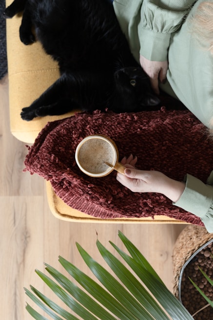person holding white ceramic mug with coffee