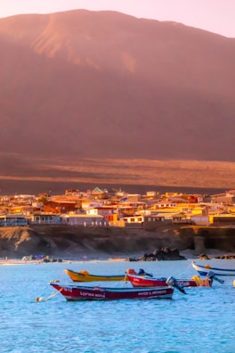 people riding on red kayak on sea during daytime