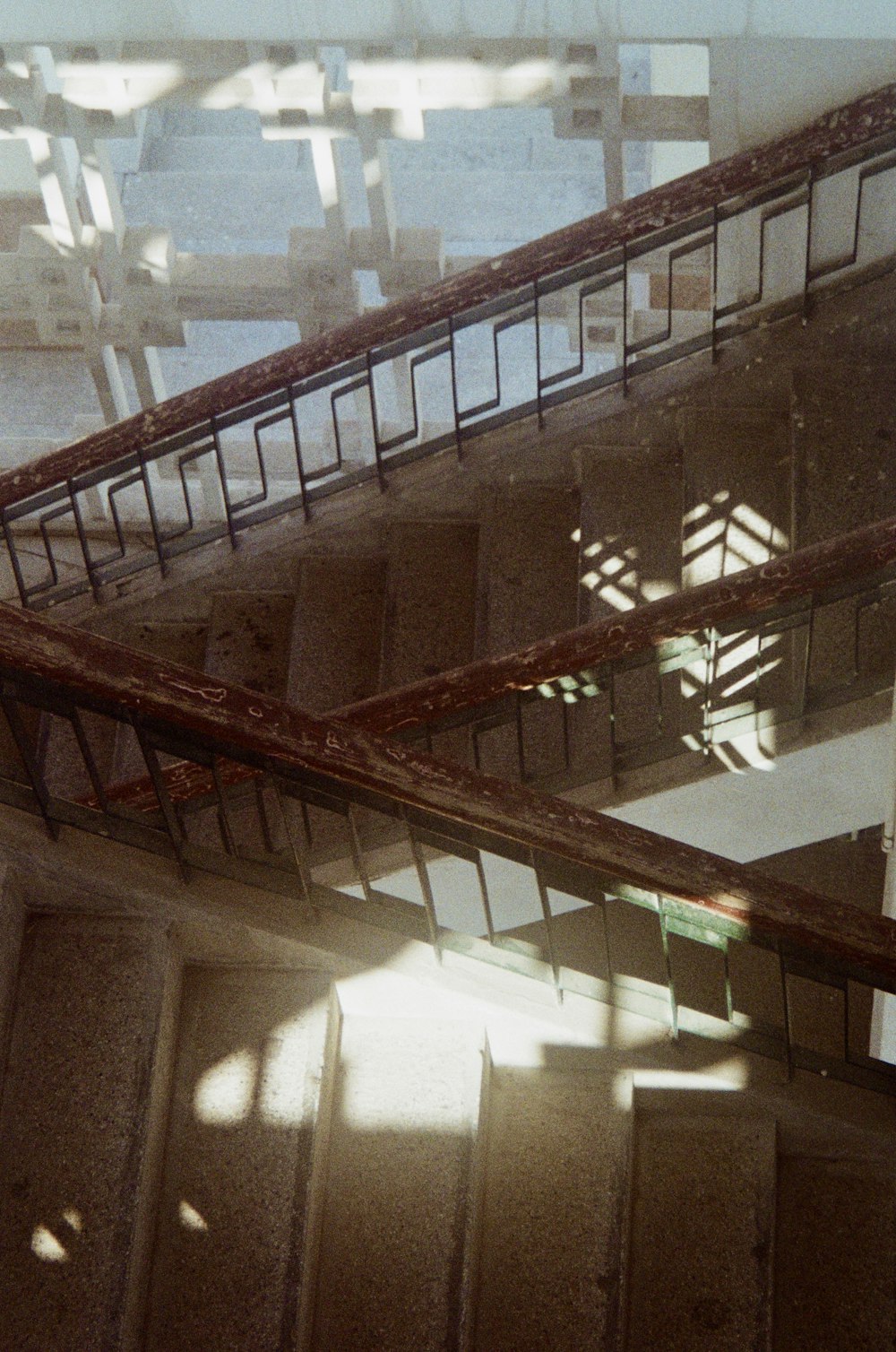 brown wooden staircase near white wall