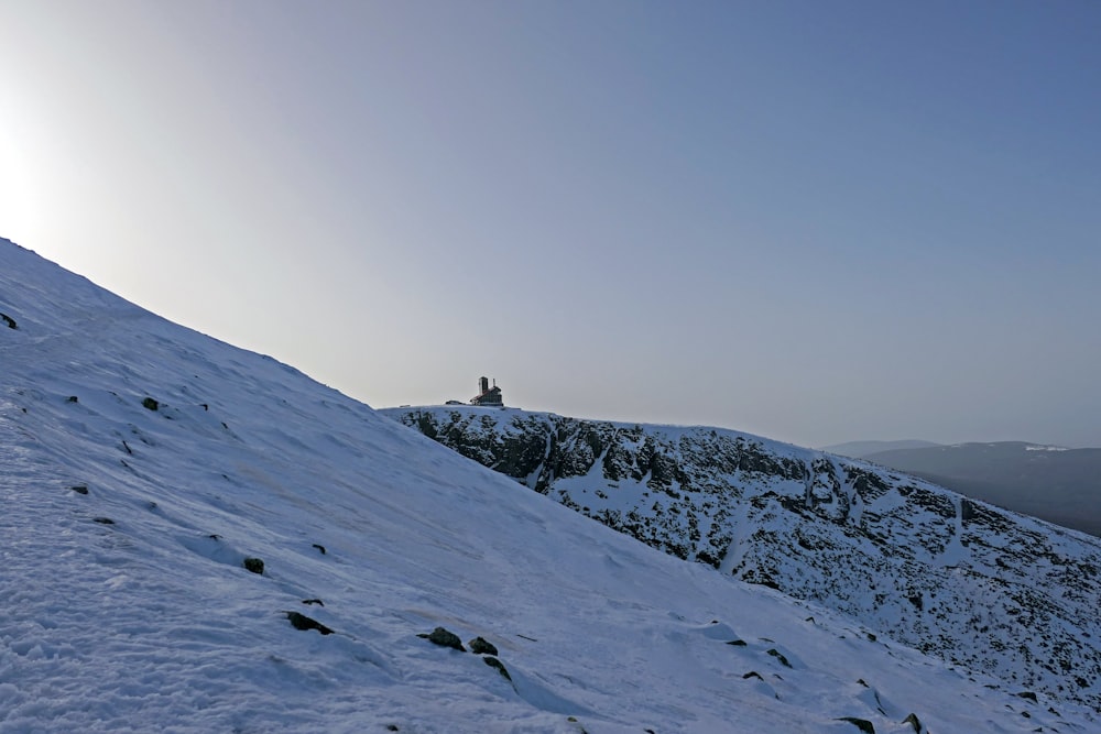 person standing on snow covered mountain during daytime