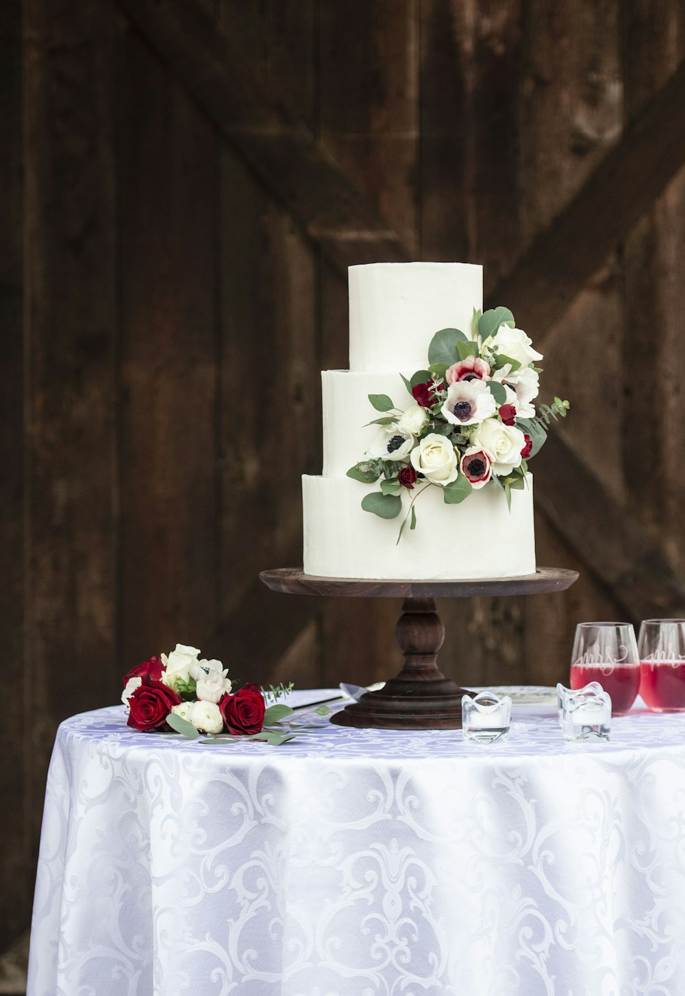 white and red roses on white round table