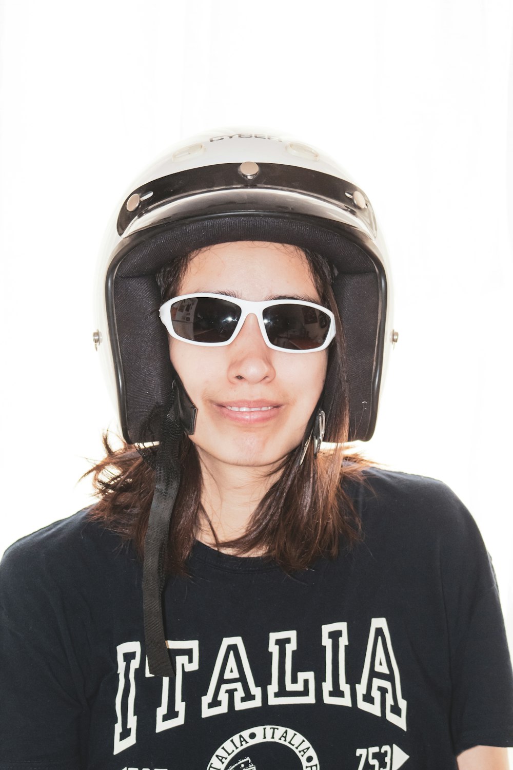 woman in black crew neck shirt wearing black and white helmet
