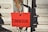 A red card with the word 'COMPASSION...' written in large black letters is attached to a metal latch on a weathered, rusted door.