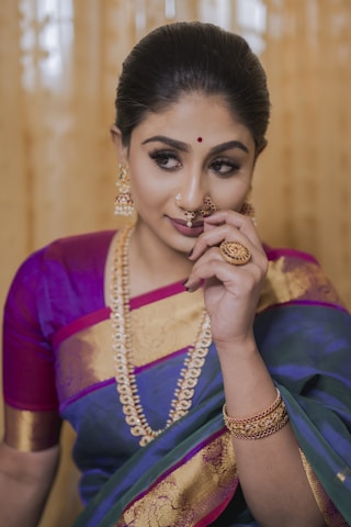 woman in purple and gold Nauvari Saree in Maharastra Style