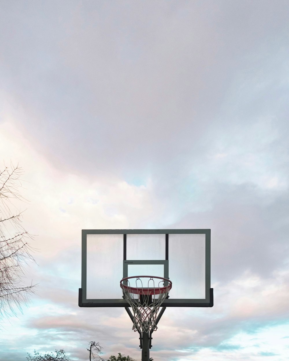 black basketball hoop under white clouds