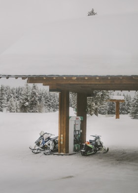 black motorcycle parked beside brown wooden post