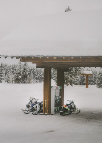 black motorcycle parked beside brown wooden post