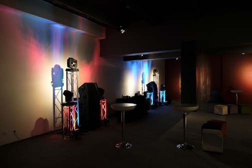 man in black jacket standing near table