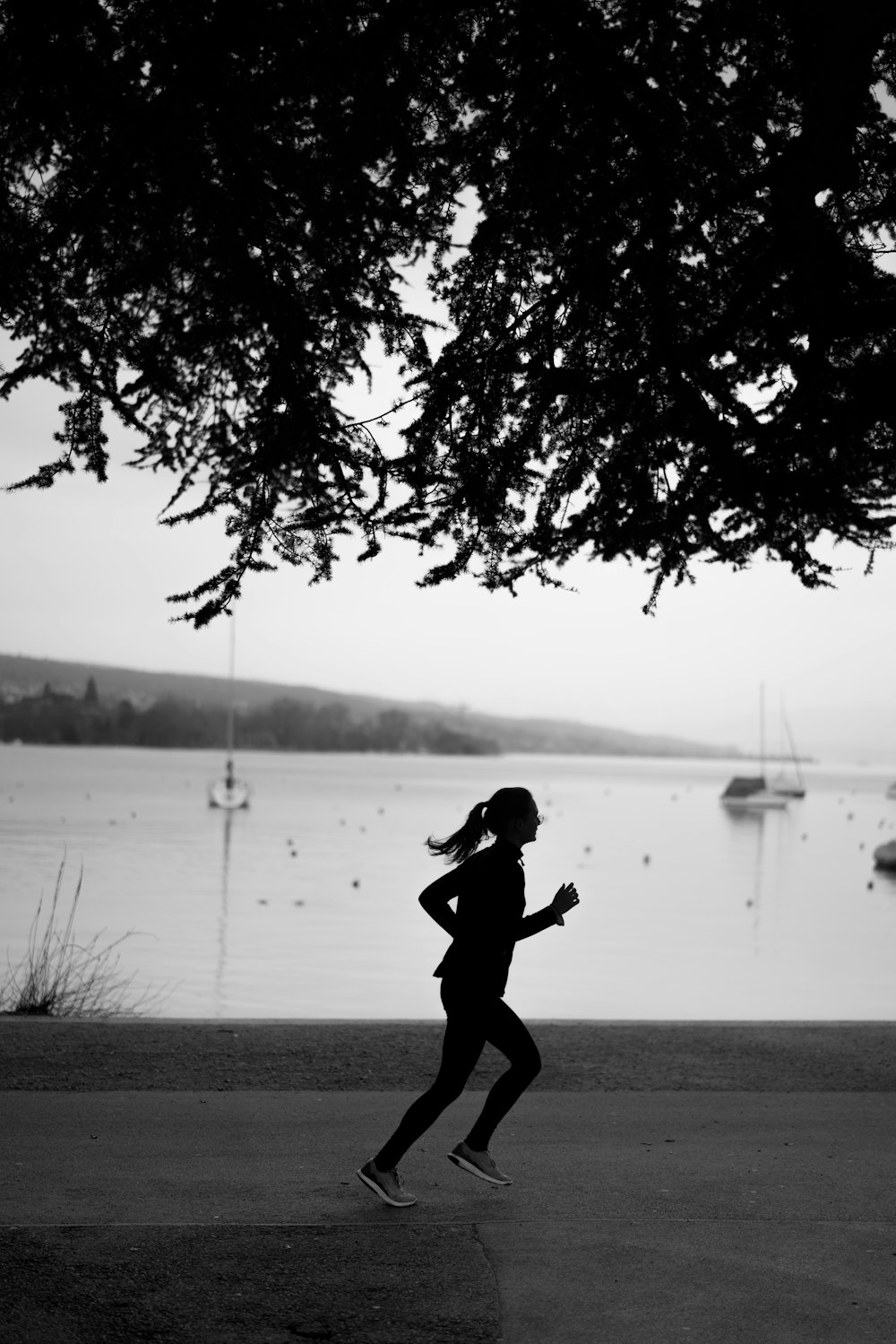 grayscale photo of man jumping on water