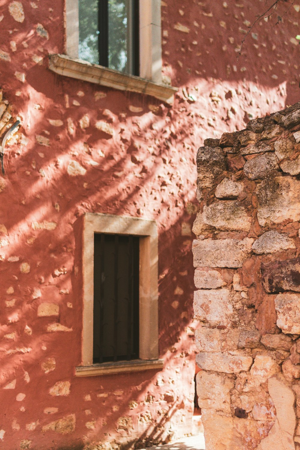 brown wooden window on brown brick wall