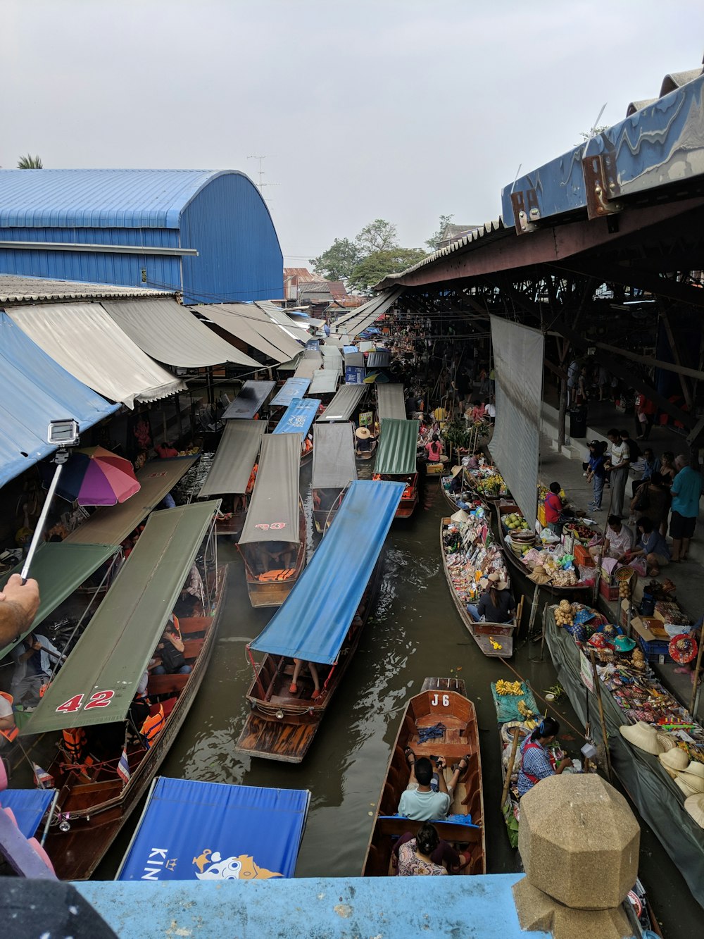 people sitting on blue and brown boat during daytime