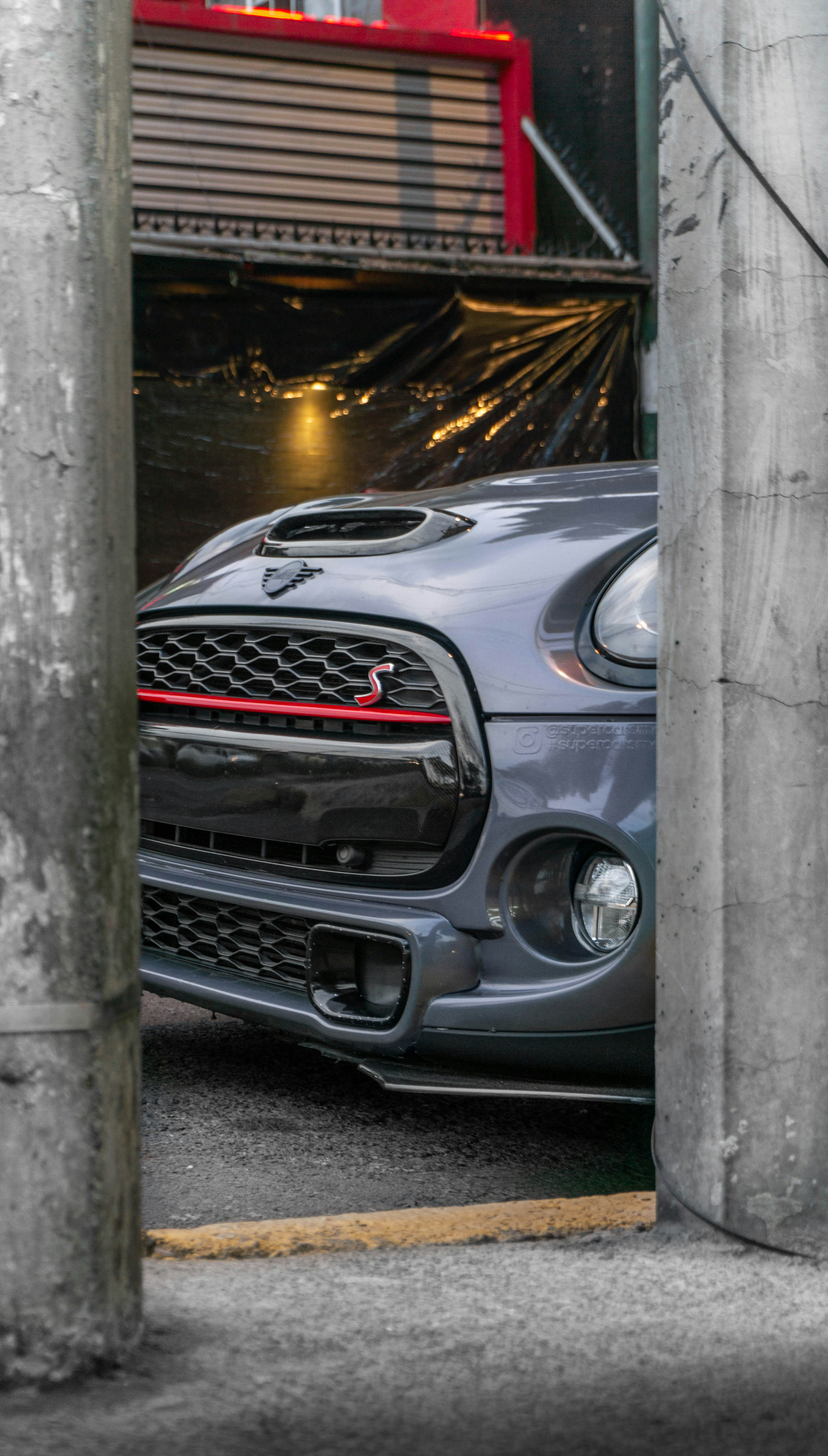 silver mercedes benz c class coupe parked beside gray concrete wall during daytime