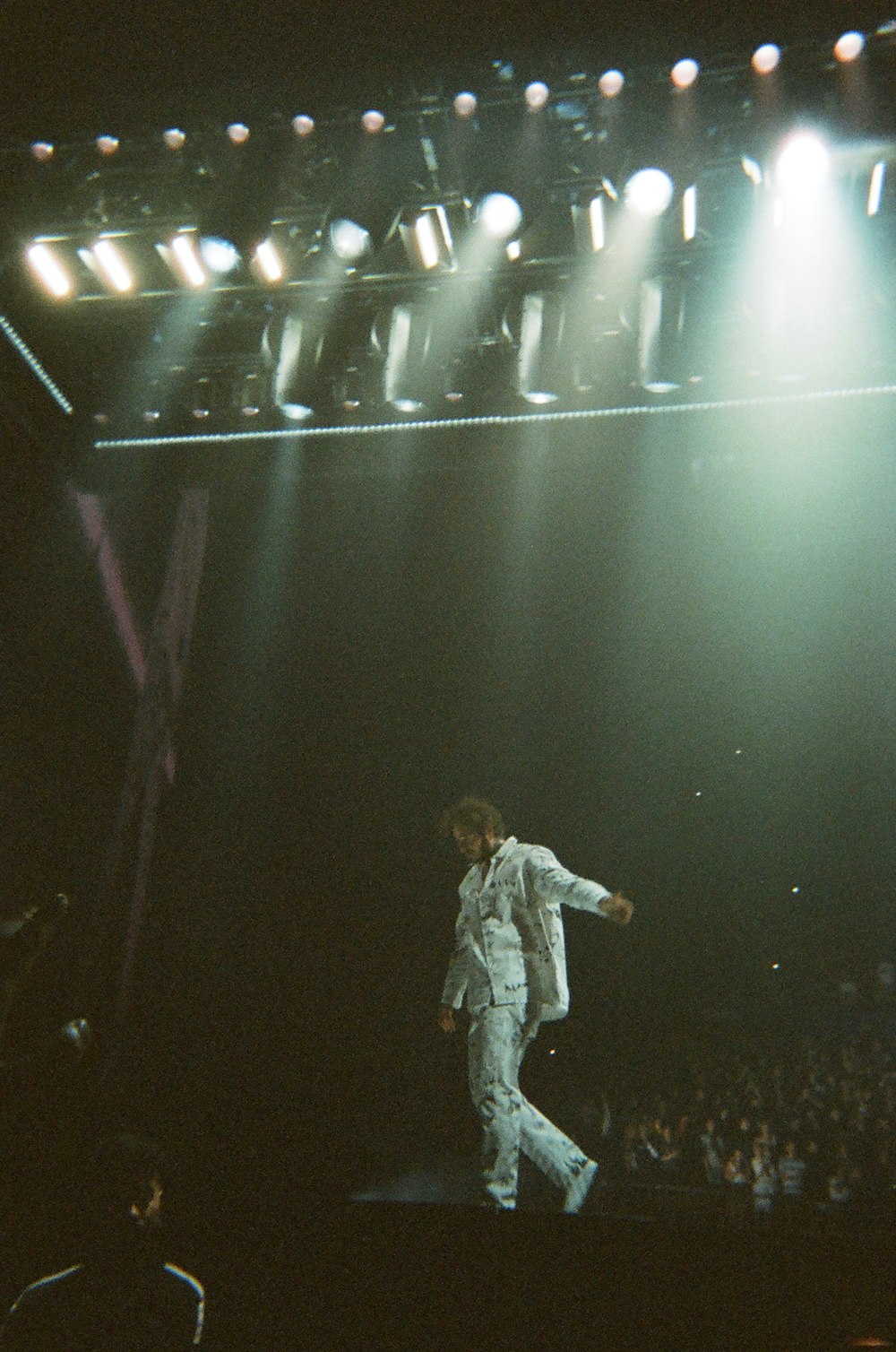 man in gray jacket standing on stage