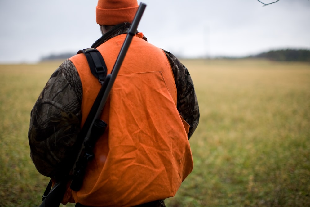 man in orange and black backpack