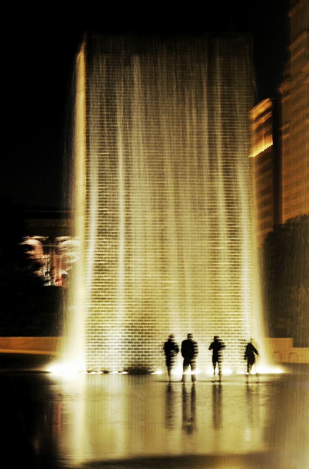 people walking on pathway in between of high rise building during daytime