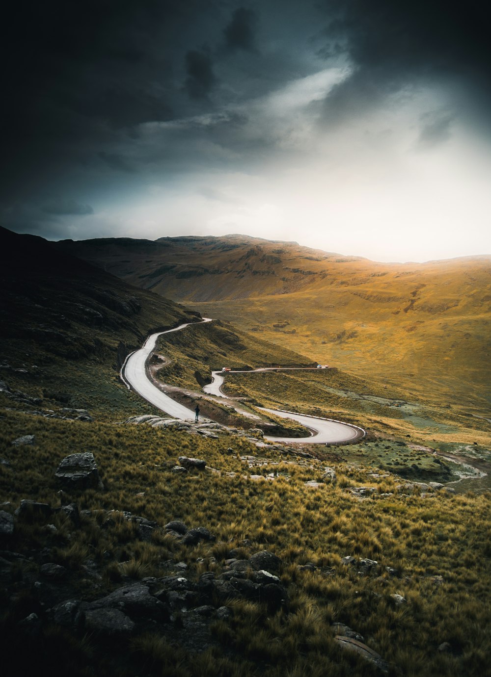 aerial view of road in the middle of brown mountains