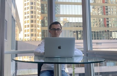 A business owner reviewing AI automation results on a tablet, city skyline in background