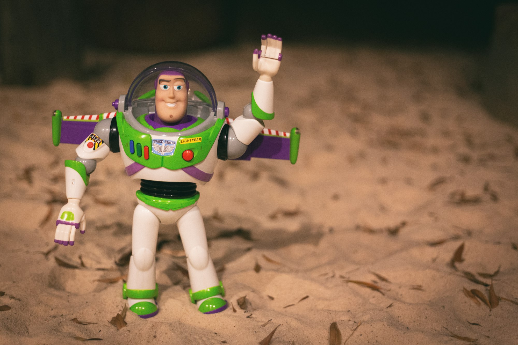 To infinity - of my sandbox. Buzz lightyear toy of the neighbor boy.