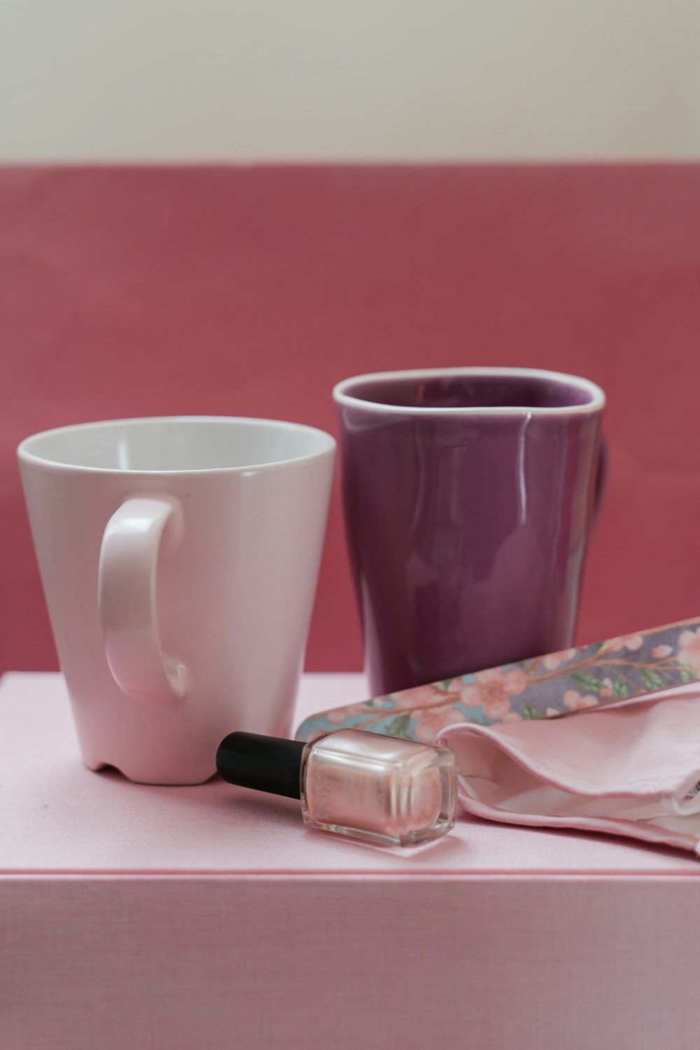white ceramic mug beside black and silver click pen