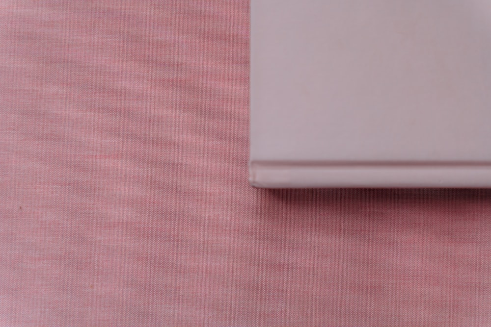 white device on pink textile