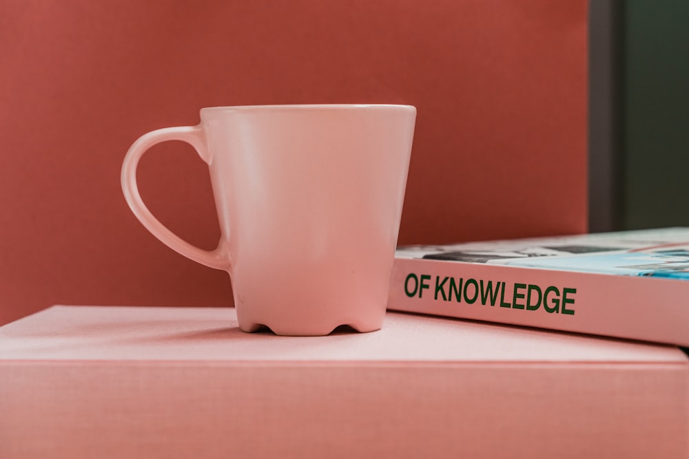 white ceramic mug on white table