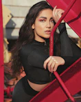 woman in black long sleeve shirt holding red scarf