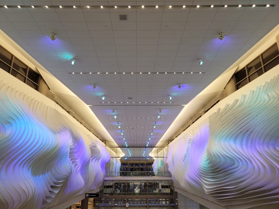 Contemporary interior with smart lighting controls casting colorful indirect light on walls