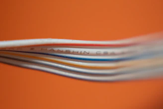 Stacks of colorful industrial cables neatly arranged in a warehouse.