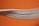 Several colored cables are stacked closely together against a bright orange background. The cables, including white, blue, and red, create a layered texture. Some text is visible on one of the cables, though it is partially blurred.