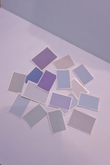 A collection of colorful prompt cards displayed on a wooden table.