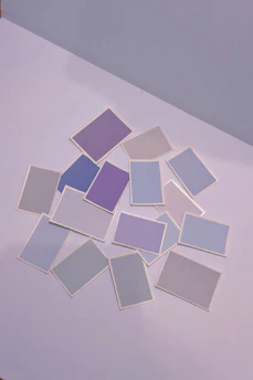 A vibrant collection of colorful trading cards spread out on a wooden table.