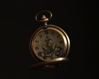 gold and silver pocket watch