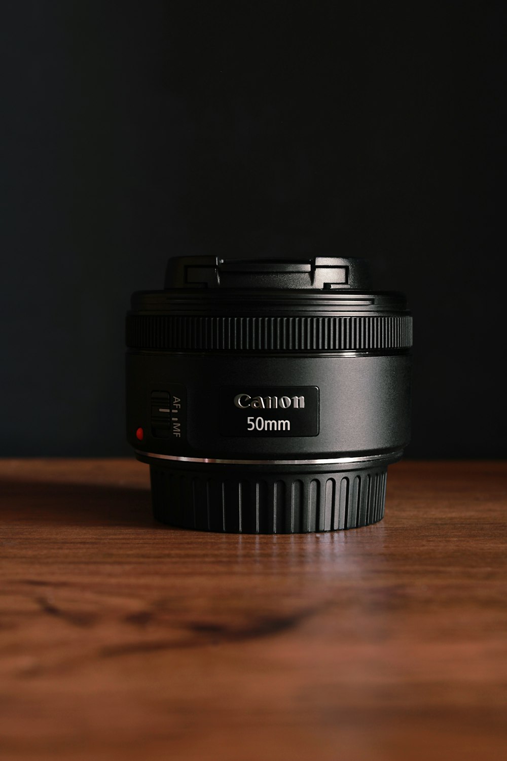 black nikon camera lens on brown wooden table